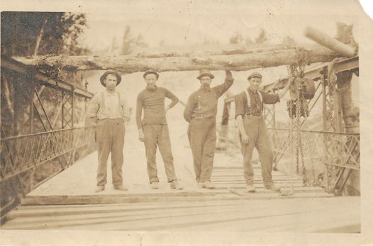 Four men repair the Old State Road Bridge circa 1900.